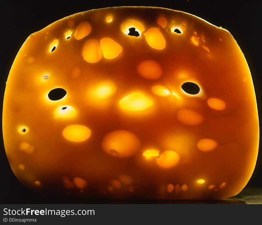 Slice of cheese on a black background