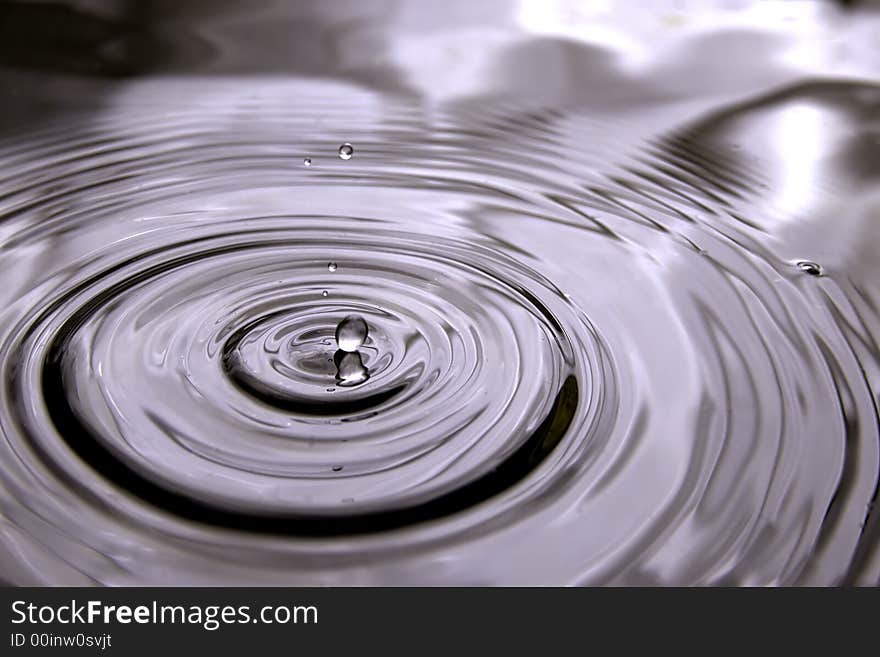 A very rare moment when the water drop is just touching the water surface, thanks to the early drop, the water surface strill have does nice circle waves and beatifull reflections. A very rare moment when the water drop is just touching the water surface, thanks to the early drop, the water surface strill have does nice circle waves and beatifull reflections.