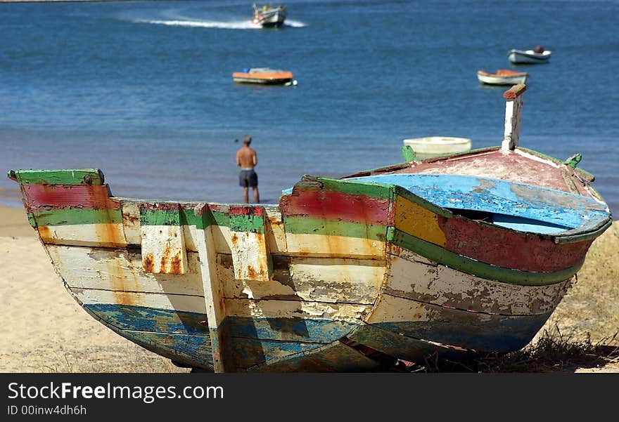 Old boat on the Ferragudo beach, Portugal.