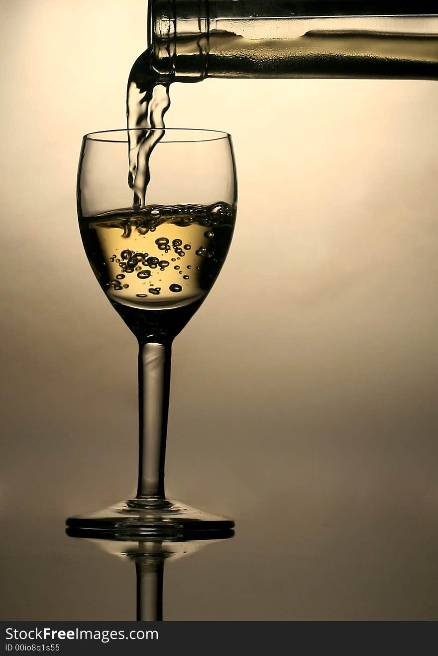 Pouring white wine in glass