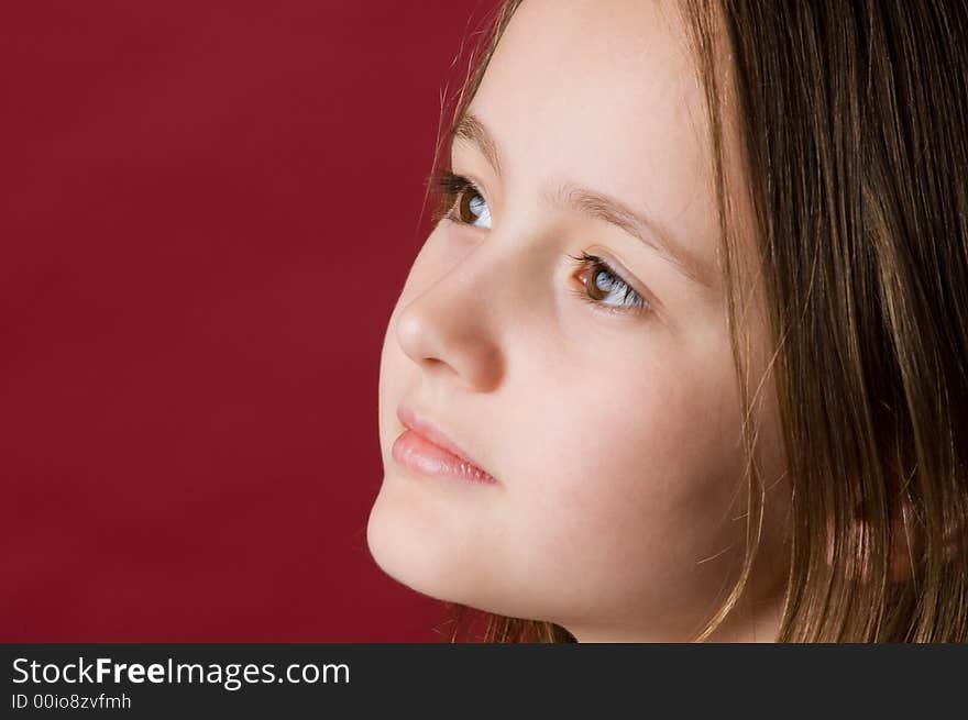 The girl of ten years on red background. The girl of ten years on red background.