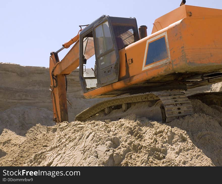 Detail on a bulldozer in top od sand