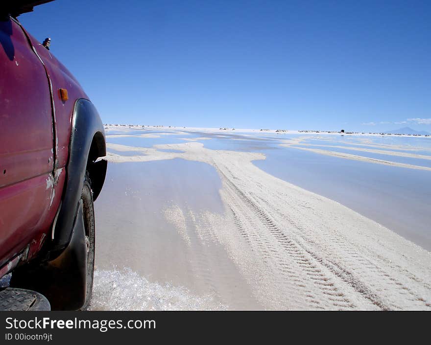 The outside of a truck driving across salt plains in Uyuni in Bolivia. The outside of a truck driving across salt plains in Uyuni in Bolivia.