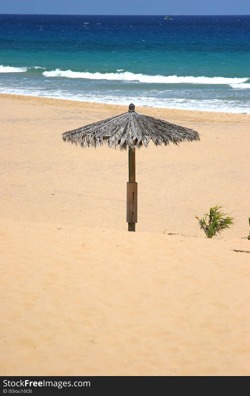 Lonely sun shade on a beach