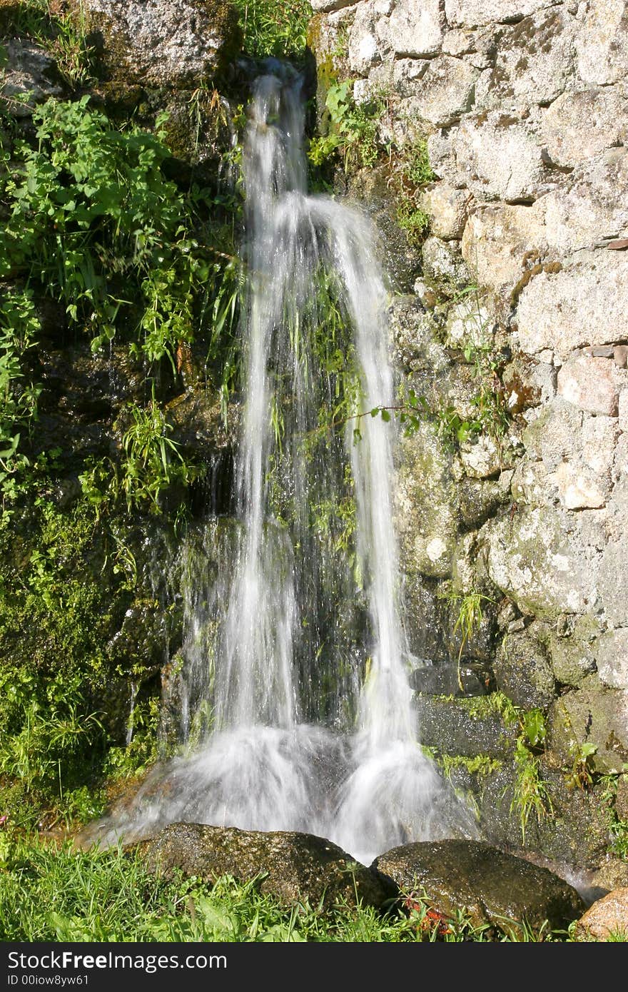 Small countryside waterfall with vegetation