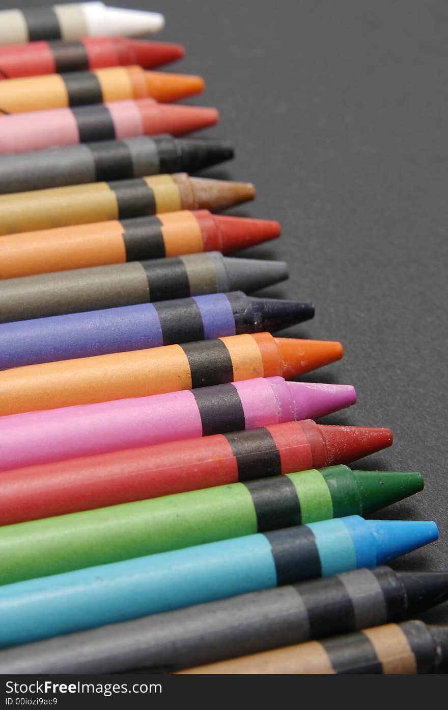 Colorful crayons against black