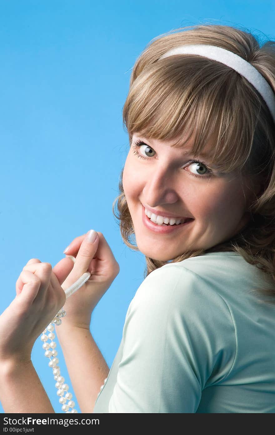 The attractive girl plays a beads on a dark blue background. The attractive girl plays a beads on a dark blue background