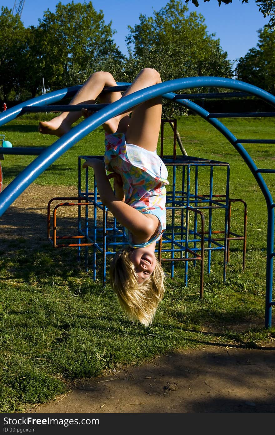 Little girl at playground in the grass