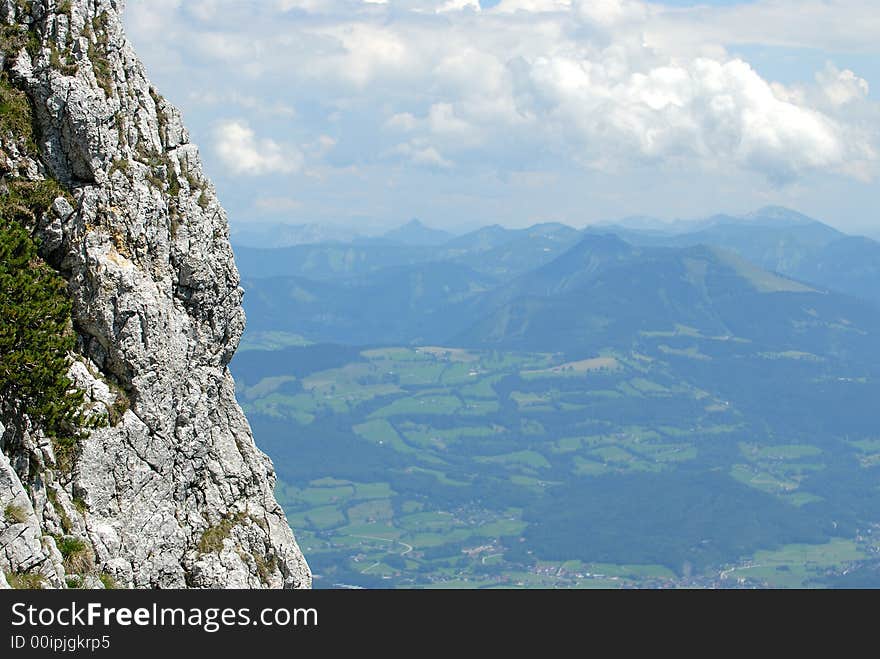 Deep precipice in the mountains with the view to the plain. Deep precipice in the mountains with the view to the plain