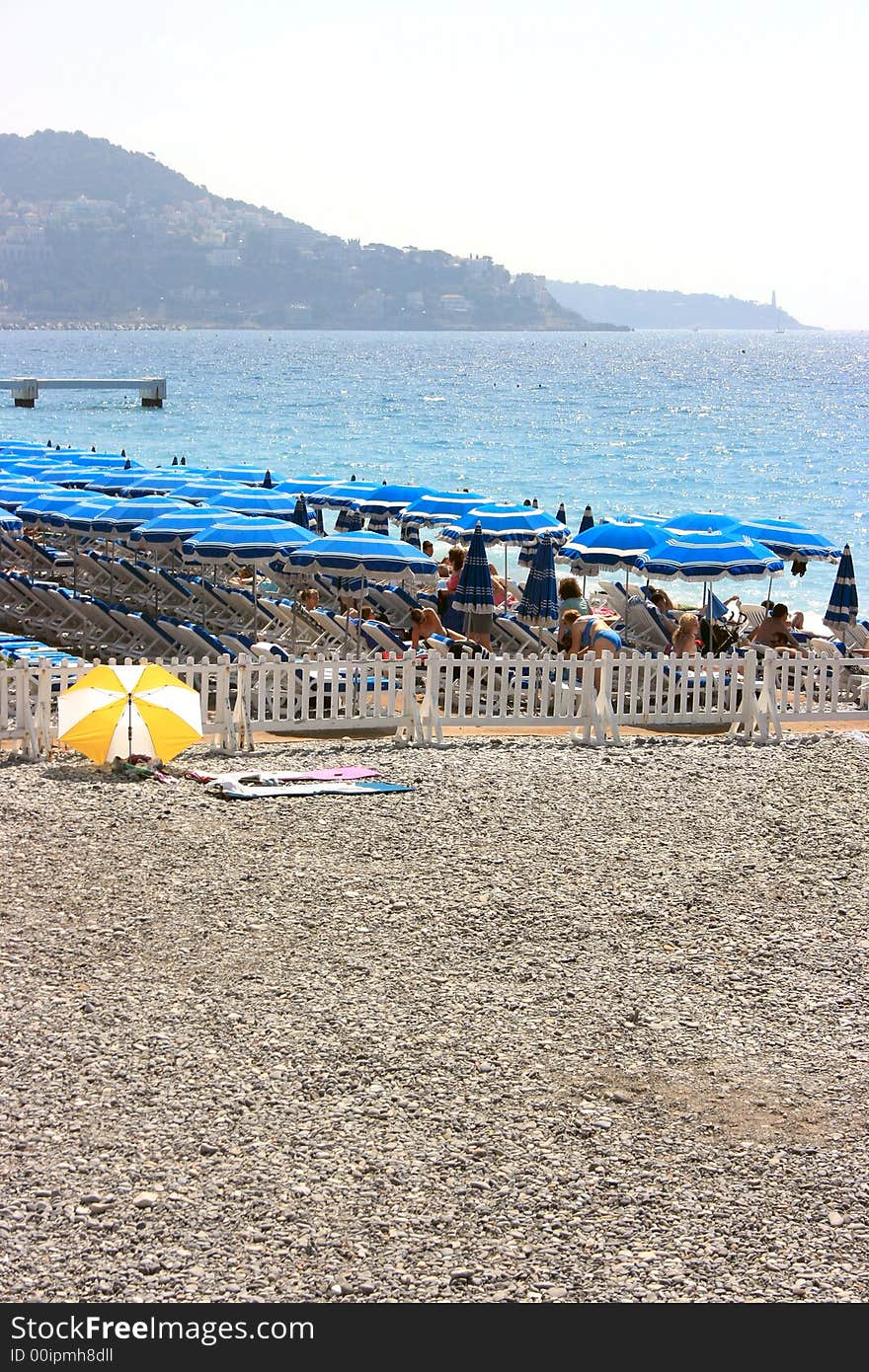 Beach with blue umbrellas