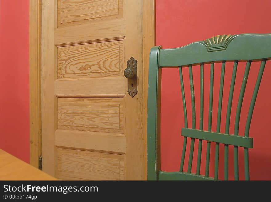 A green chair against a red wall