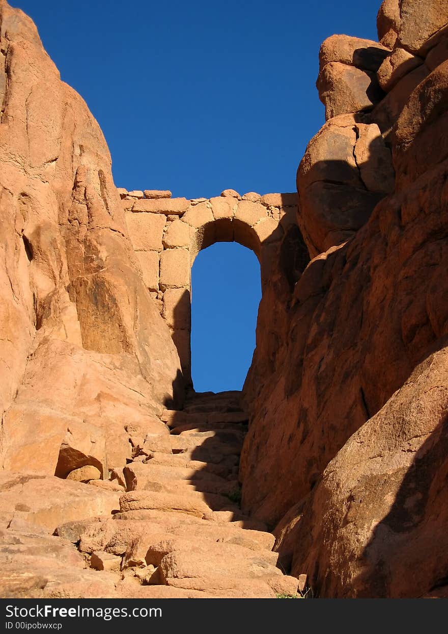 A rock archway in the middle of the desert