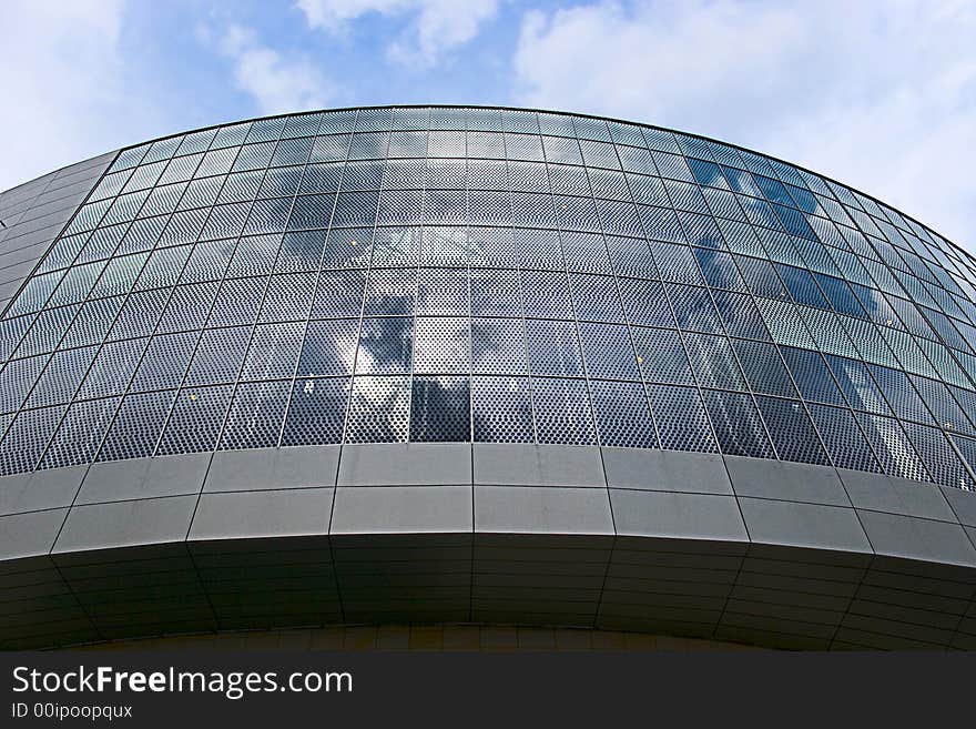 Glass front of shopping mall with reflection  of sky. Glass front of shopping mall with reflection  of sky