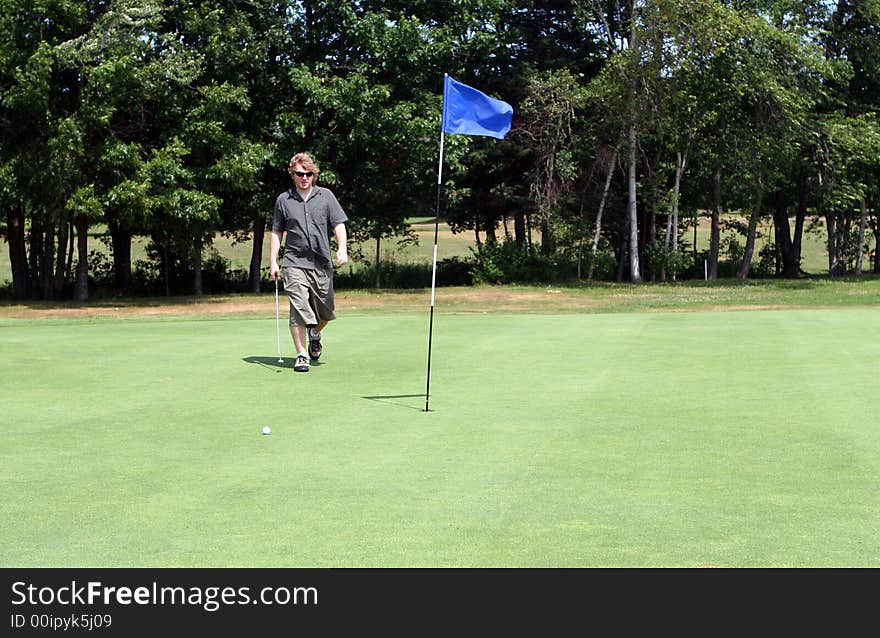 Man playing golf on the course. Man playing golf on the course.