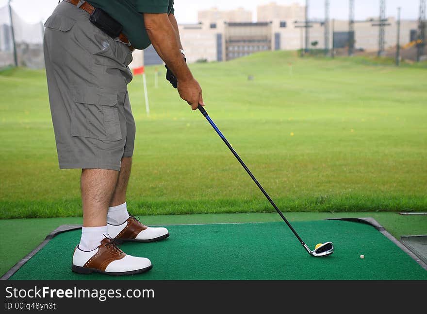 Senior golfer play golf in the city golf school field. Senior golfer play golf in the city golf school field