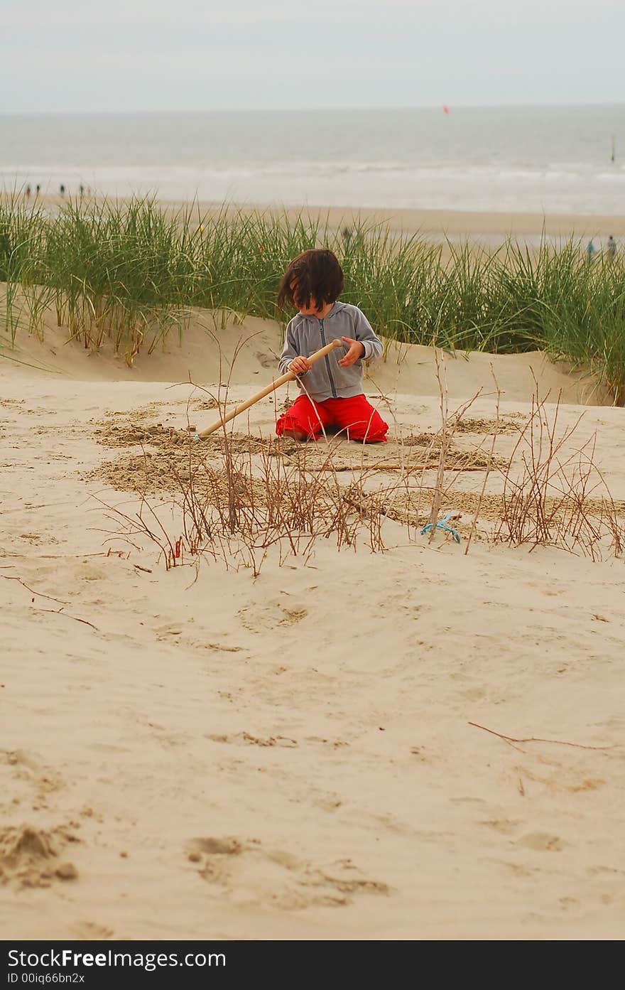 Small girl playing in dunes