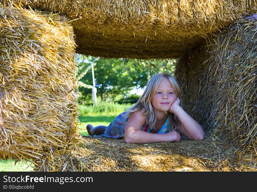 Cute girl on haybales