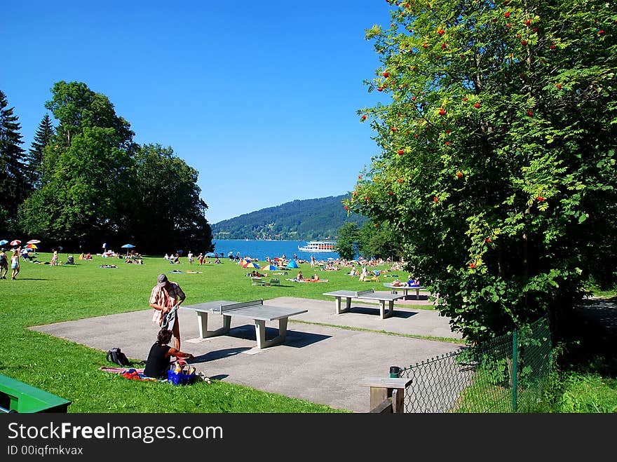 People by a beach of a sea. Tegernsee bavaria. People by a beach of a sea. Tegernsee bavaria