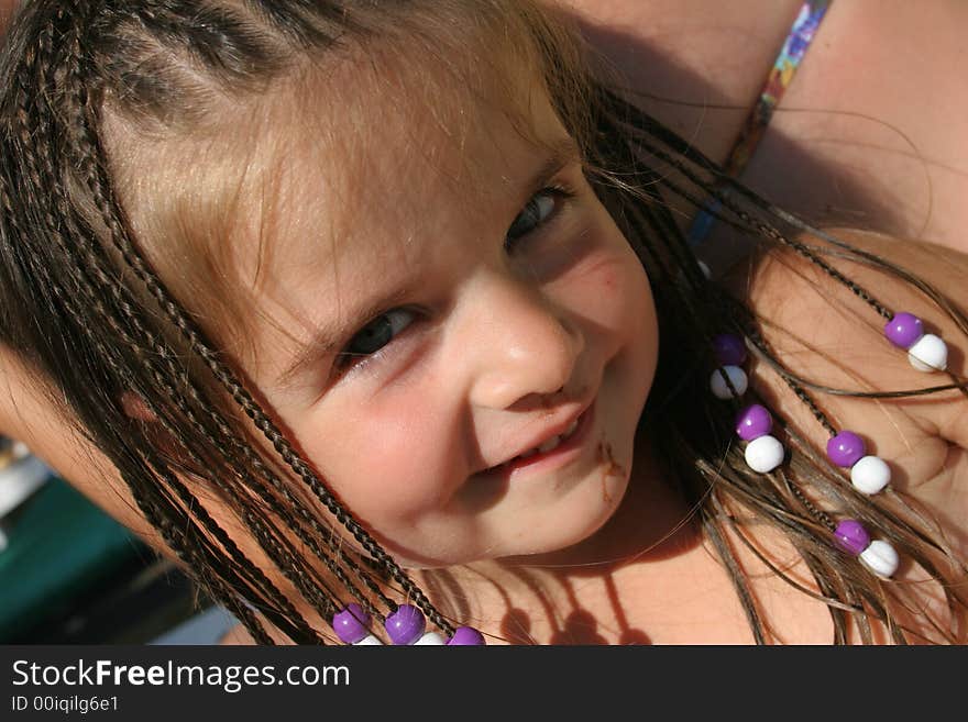 Little smiling girl with blue and white plait. Little smiling girl with blue and white plait