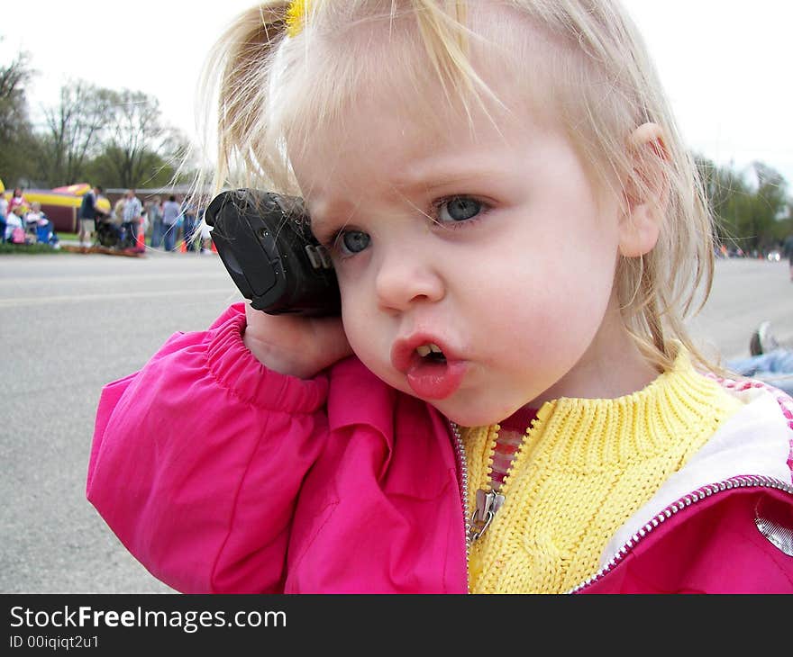 Little girl having a serious conversation on a cellular phone. Little girl having a serious conversation on a cellular phone.