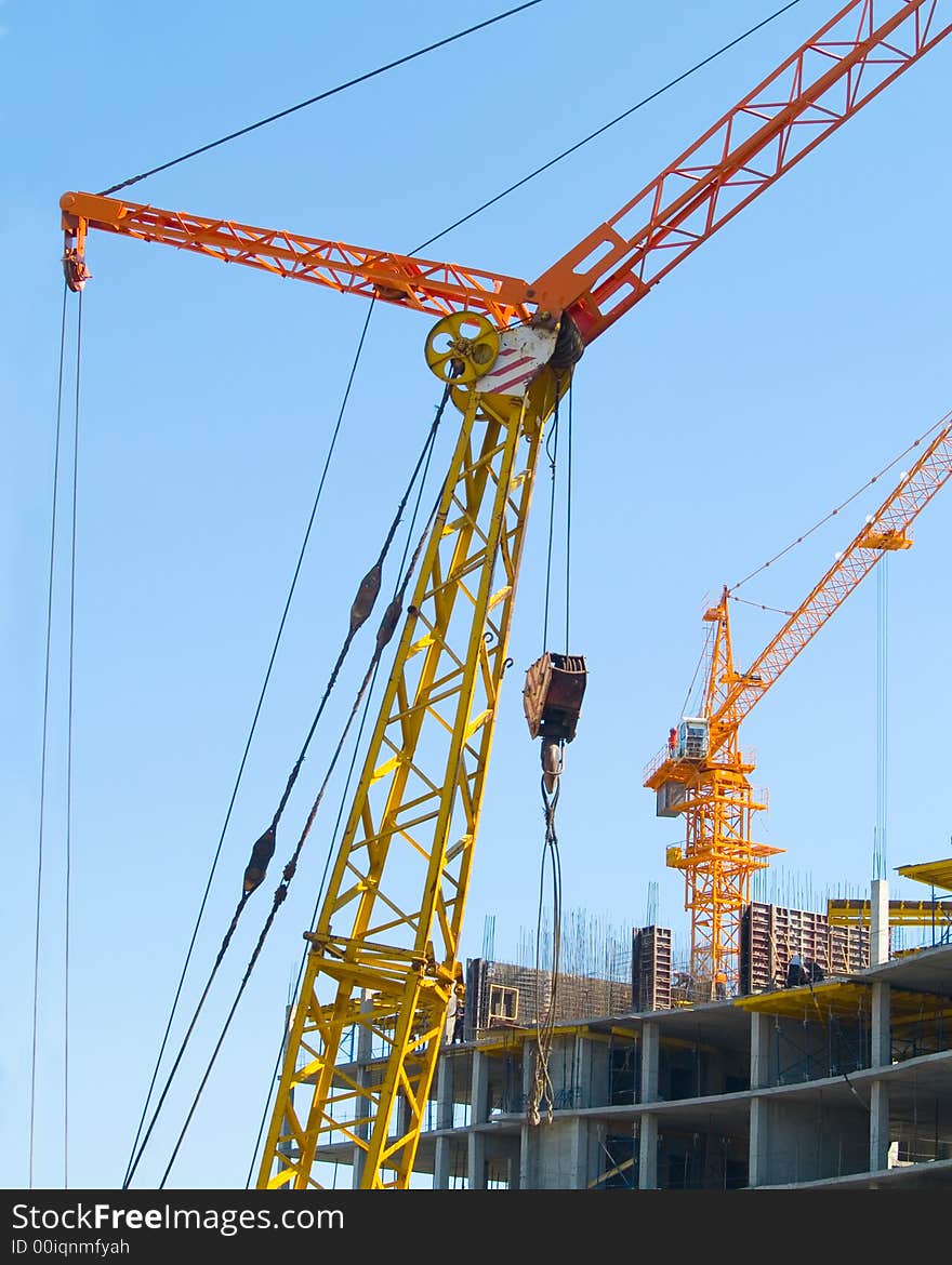 Building construction cranes in the blue sky