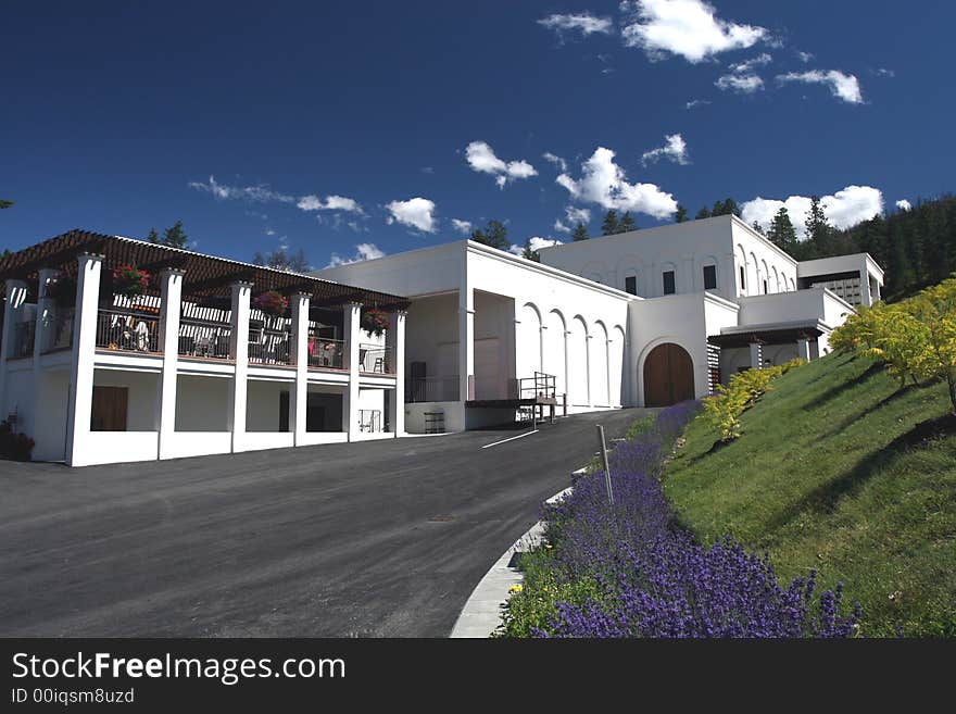 Modern winery set against a lush hill. Modern winery set against a lush hill.