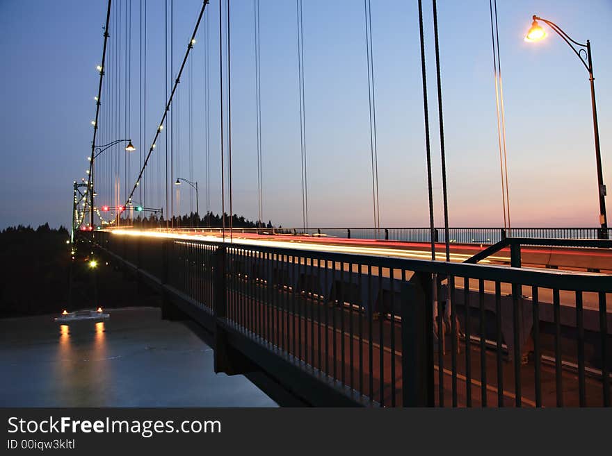 Streaking headlights in motion on bridge