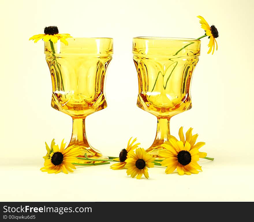 Black-eyed susans flowers and drinking glasses still life. Black-eyed susans flowers and drinking glasses still life