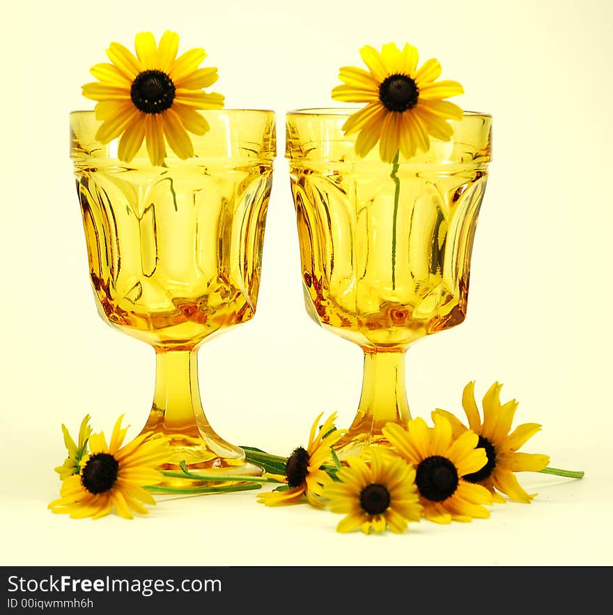Black-eyed susans flowers and drinking glasses still life. Black-eyed susans flowers and drinking glasses still life
