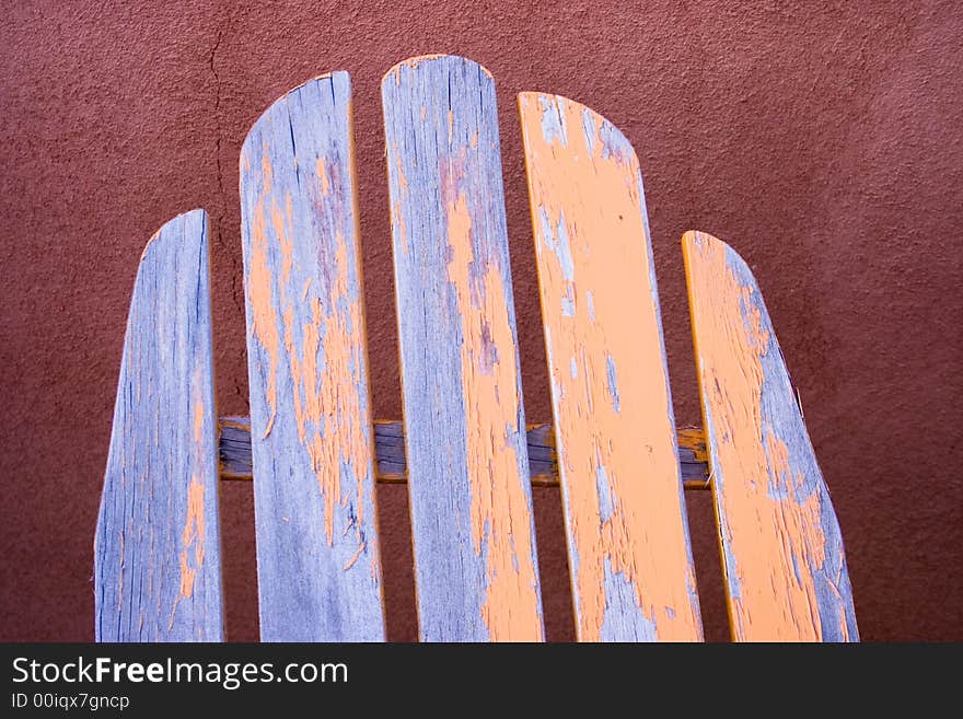 Top section of old wooden chair with peeling yellow paint. Top section of old wooden chair with peeling yellow paint