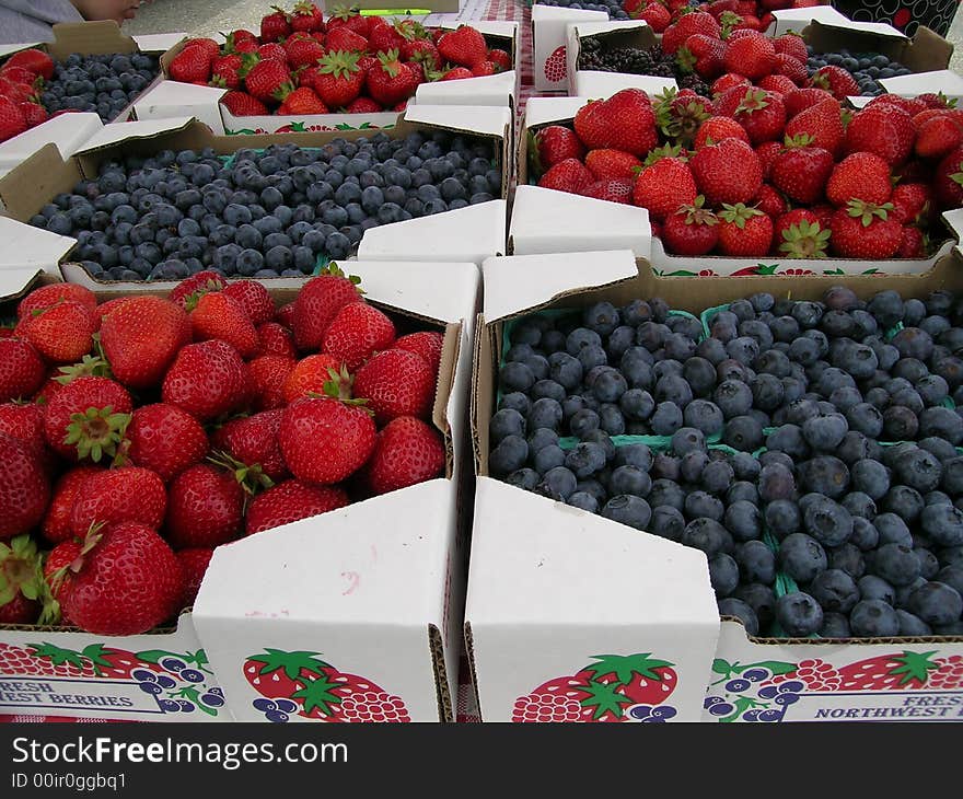 Strawberries and Blueberries on for sale at Farmers Market. Strawberries and Blueberries on for sale at Farmers Market