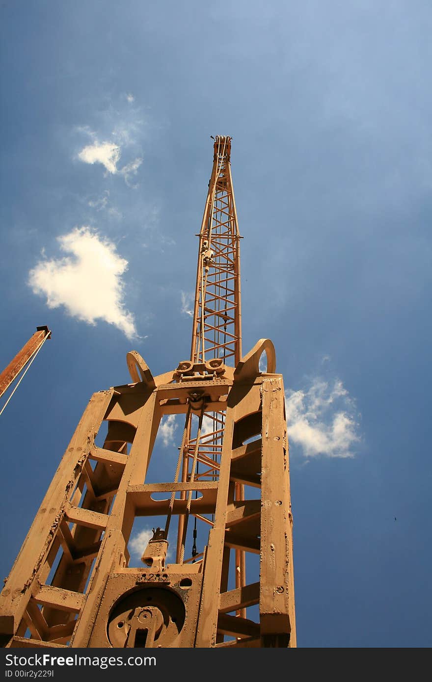 Steel crane drilling foundations for a train station. Steel crane drilling foundations for a train station