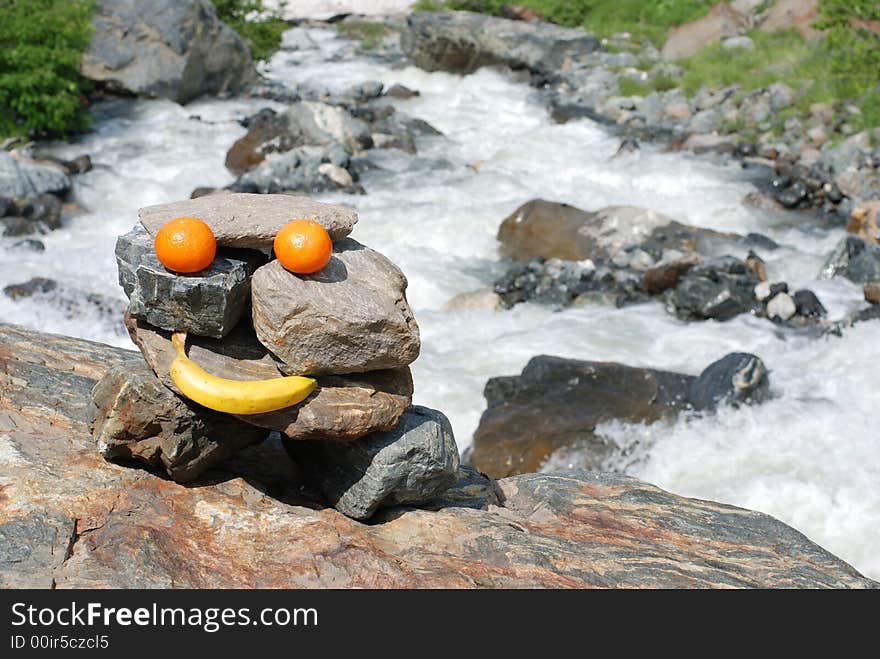 Smiling figure from fruits and stones. Smiling figure from fruits and stones