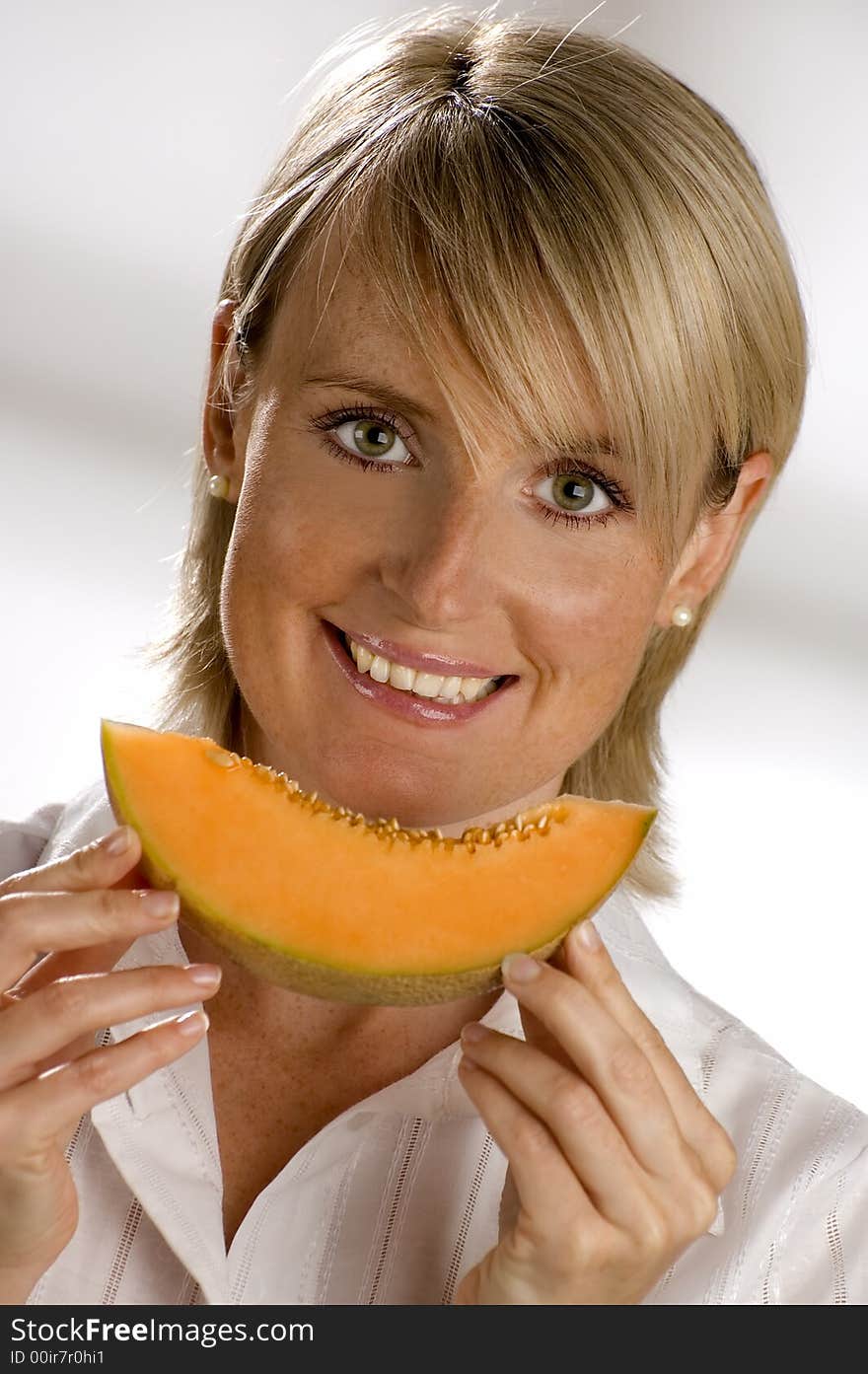 Young woman eating a juicy cantaloupe close up. Young woman eating a juicy cantaloupe close up