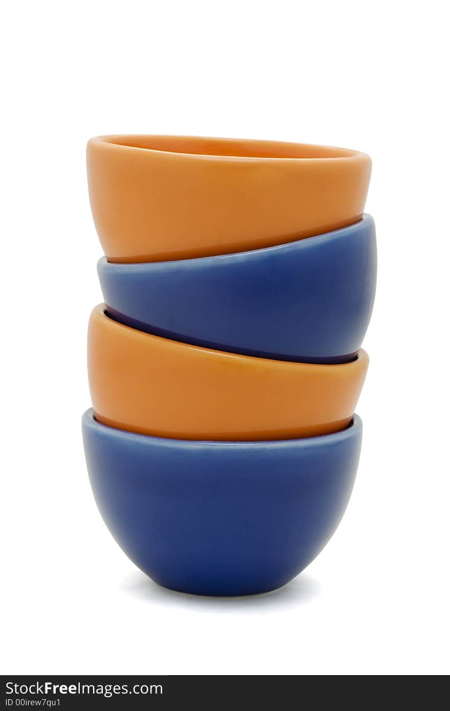 Orange and blue stacked cups isolated on white. Orange and blue stacked cups isolated on white.