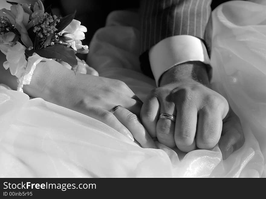 Bride and groom hands close up in black and white