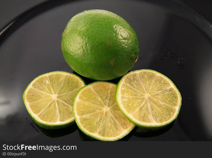 Fresh lime on a colorful charger. Fresh lime on a colorful charger