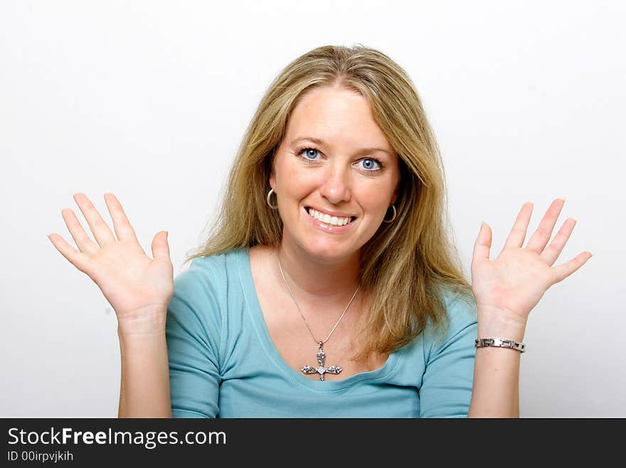 A young lady with her hands up smiles into the camera. A young lady with her hands up smiles into the camera.