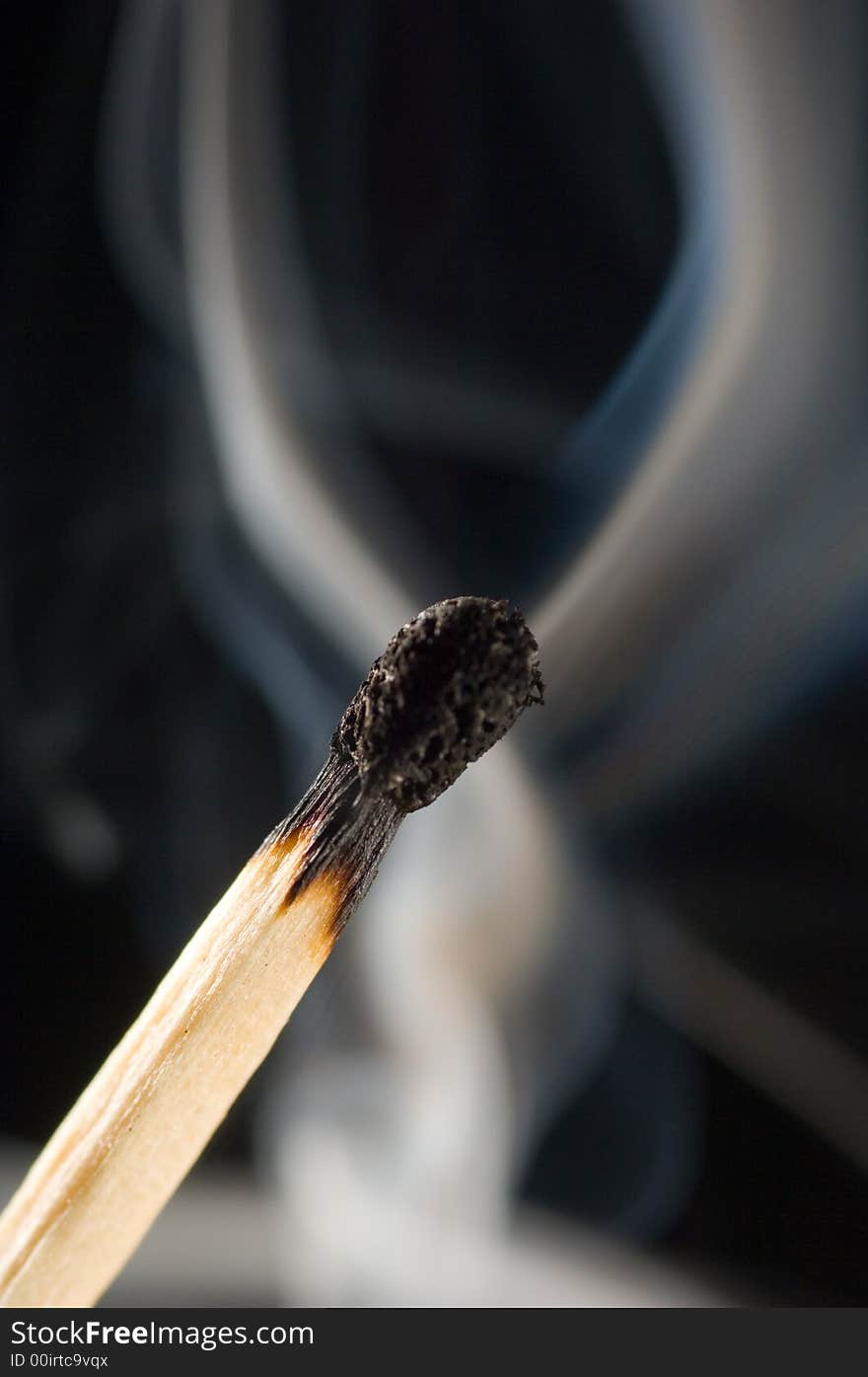 Close up of a smoking match on a black background