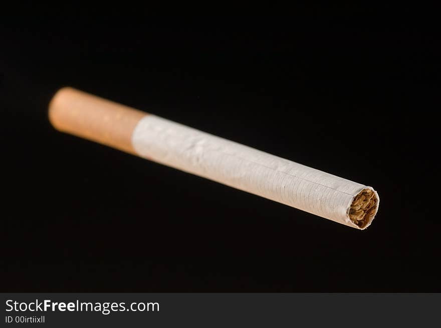 An isolated cigarette on black background