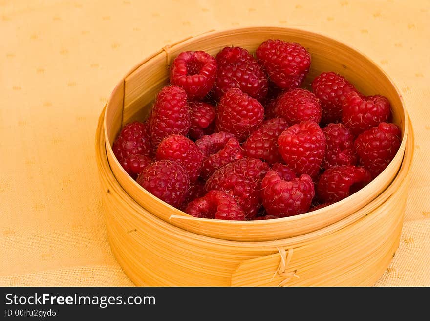 Sweet summer raspberries in the wooden box