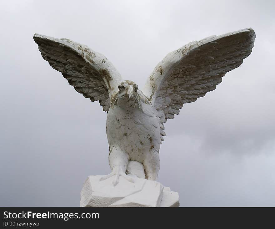 An old sand weathered statue of a falcon. An old sand weathered statue of a falcon