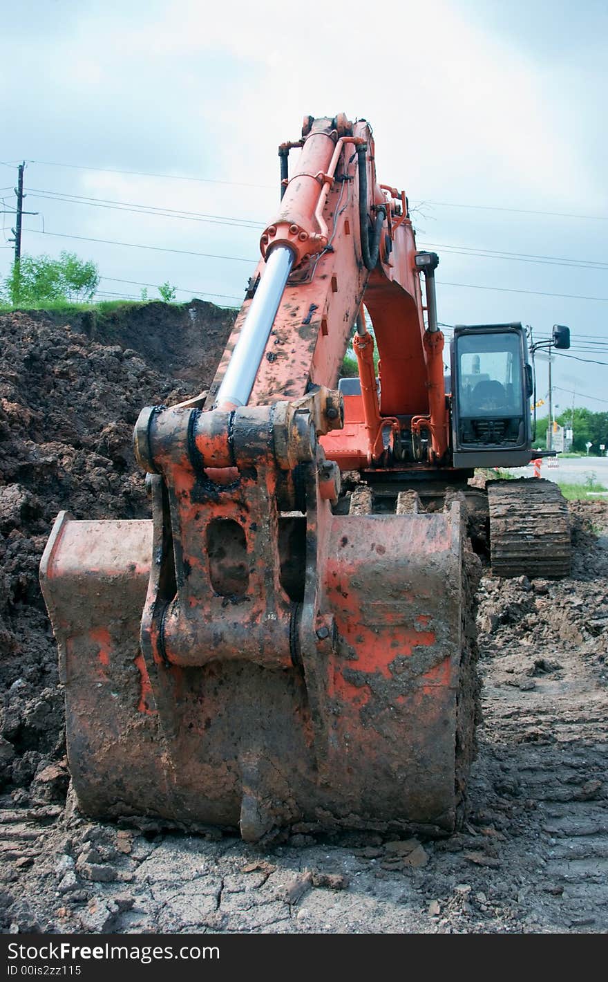 The dirt encrusted bucket and hydraulic arm of an Excavator. The dirt encrusted bucket and hydraulic arm of an Excavator.