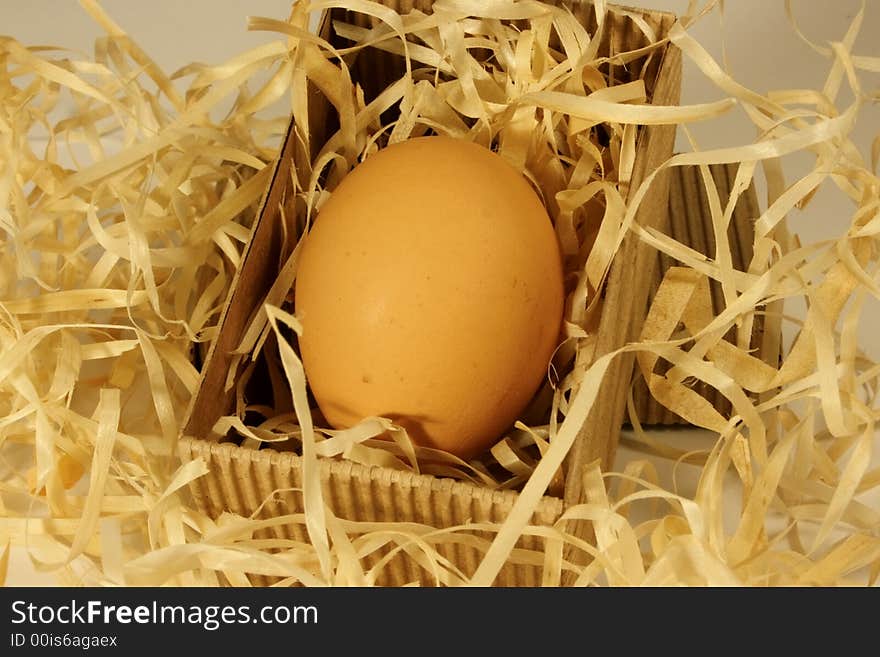 Egg lying in a cardboard box on some straw. Egg lying in a cardboard box on some straw