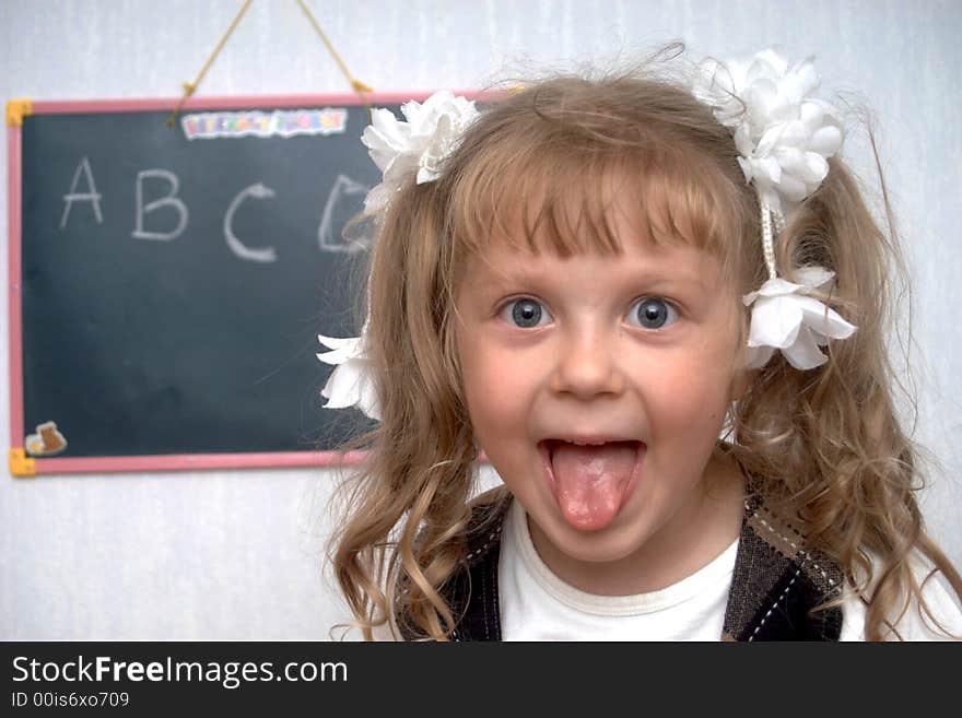 An image of girl on a first lesson at school. An image of girl on a first lesson at school