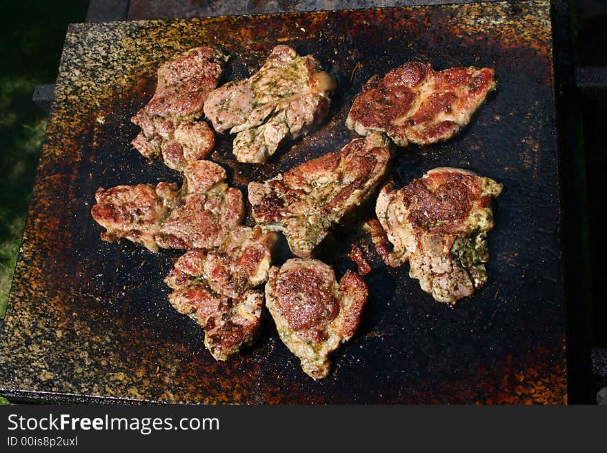 Baking pieces of meat on grill. Baking pieces of meat on grill