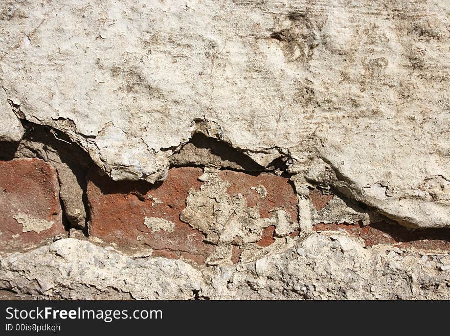 Broken old wall with plaster missing and bricks showing. Broken old wall with plaster missing and bricks showing