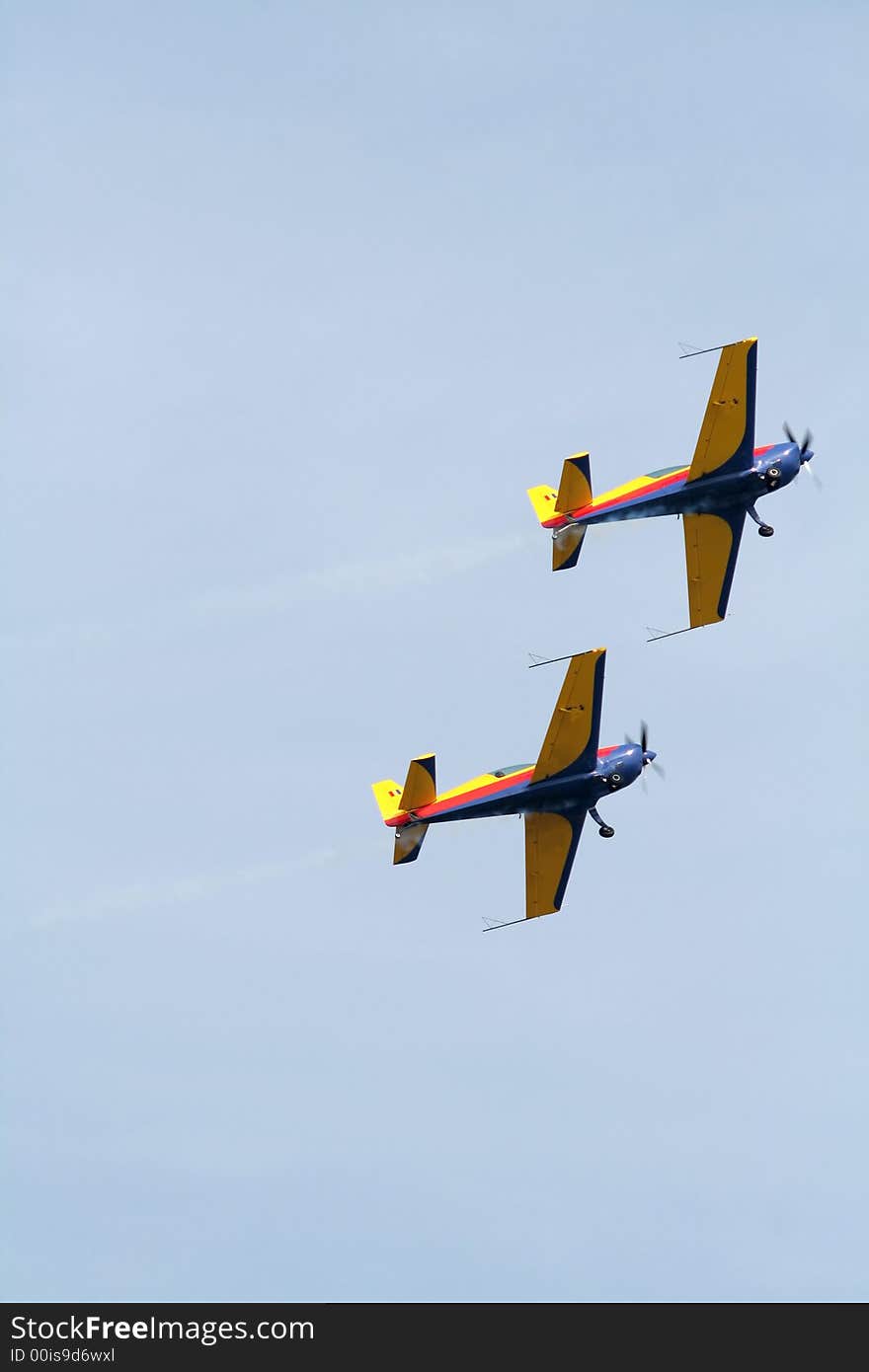 Two airplane doing aerial acrobatics at low altitude. Two airplane doing aerial acrobatics at low altitude