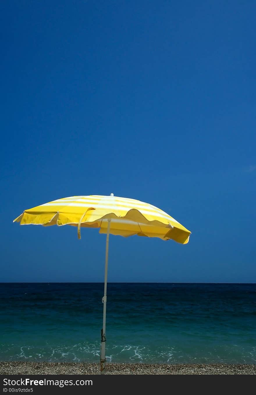 Yellow parasol on beach