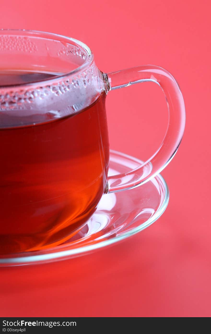 Cup of tea on red background